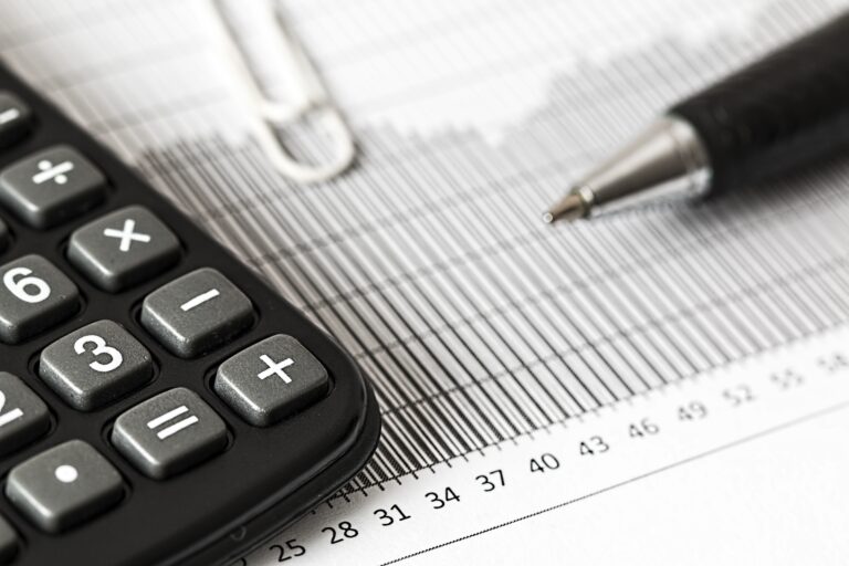 Calculator placed on a piece of paper for taxation purposes